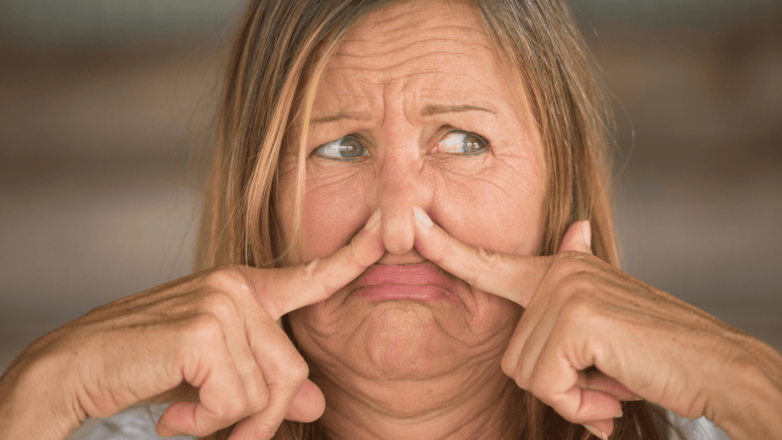 Woman Holding Her Nose