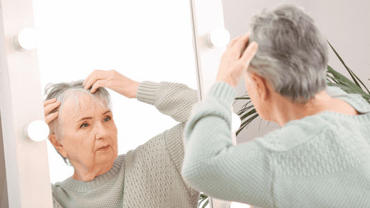 Woman Looking at Hair in Mirror