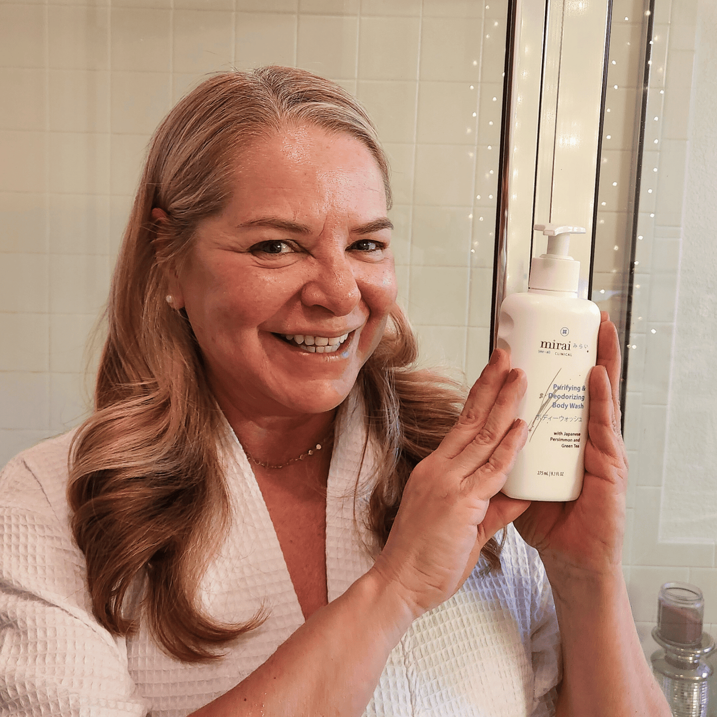 Customer holding Mirai Clinical’s body wash, enriched with natural persimmon extract to effectively combat nonenal and refresh body odor.