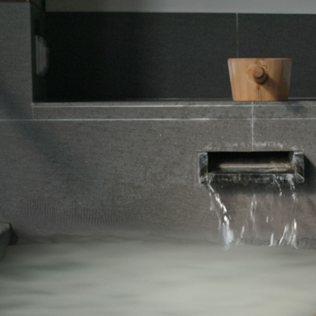 Bath filled with Mirai Clinical deodorizing bath salts for odor removal.