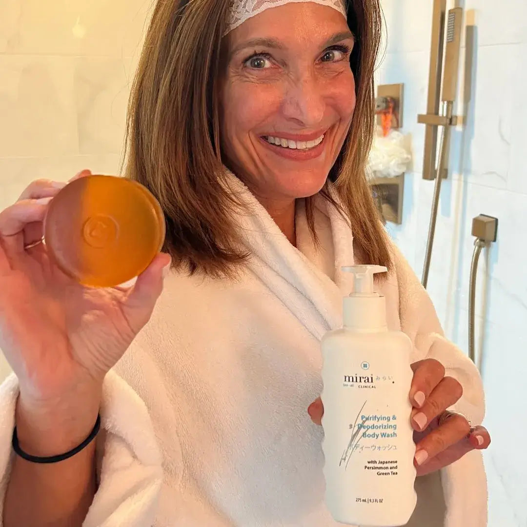 Woman holding Mirai Clinical Deodorizing Soap and Body Wash, effective for reducing nonenal and body odor.