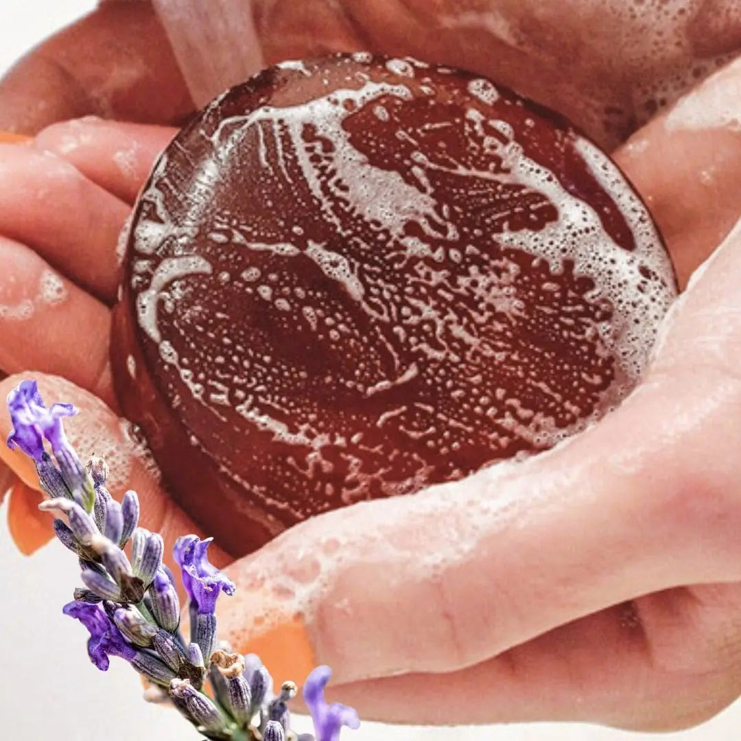 Mirai Clinical Lavender Persimmon Soap Bar lathered in hands – natural deodorizing soap to eliminate nonenal body odor and refresh skin.