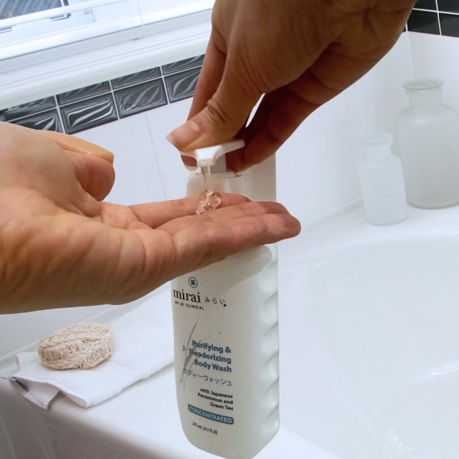 Close-up of Mirai Clinical Purifying & Deodorizing Body Wash being dispensed onto hand, formulated to neutralize Nonenal body odor with Japanese persimmon and green tea.