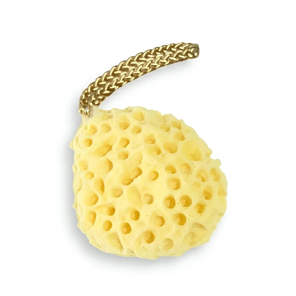 A natural yellow porous sponge bath bomb holder with a braided gold metal loop at the top, shown on a plain white background.