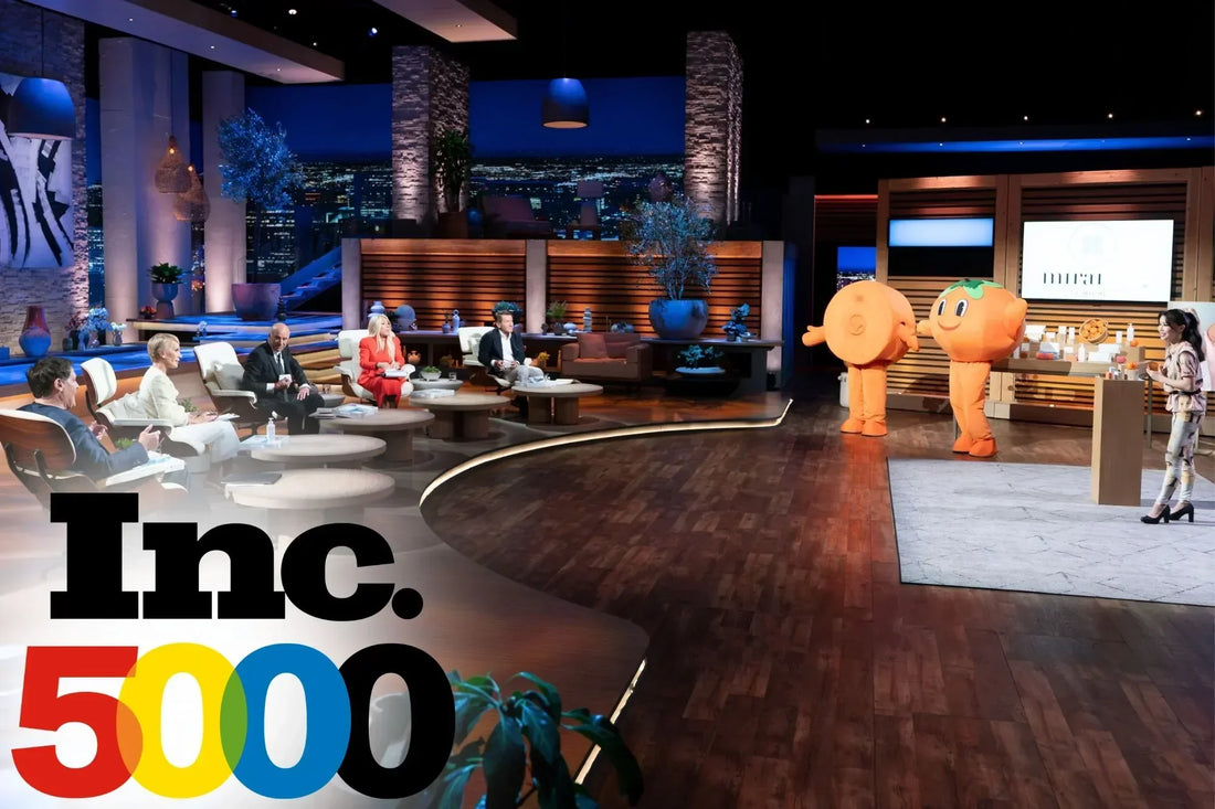 Koko Hayashi, founder of Mirai Clinical, presents Mirai Clinical products on the Shark Tank set alongside two orange mascots, with the Sharks seated on stage and the Inc. 5000 logo in the foreground.