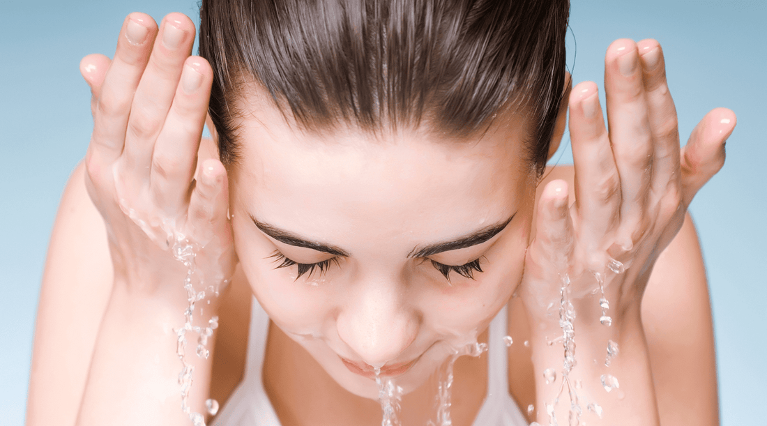 Woman Splashing Water on Face