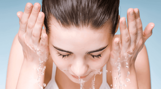 Woman Splashing Water on Face