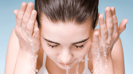 Woman Splashing Water on Face