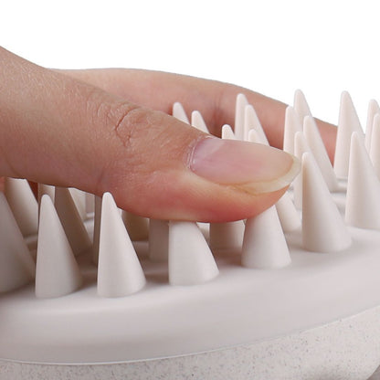 Close-up of Mirai Clinical Scalp Massager showing soft silicone bristles.