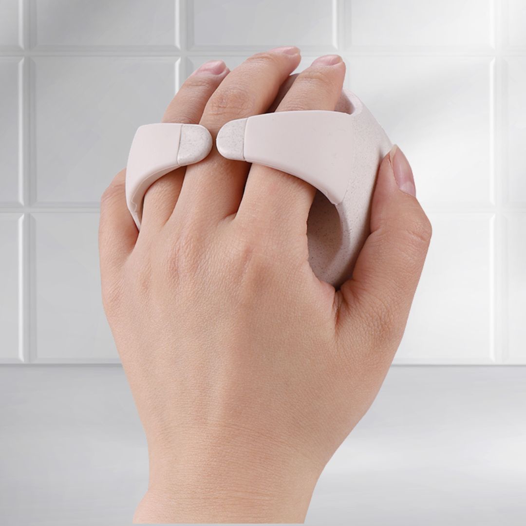 Back view of Mirai Clinical Scalp Massager held in hand, highlighting its ergonomic grip and soft silicone bristles.