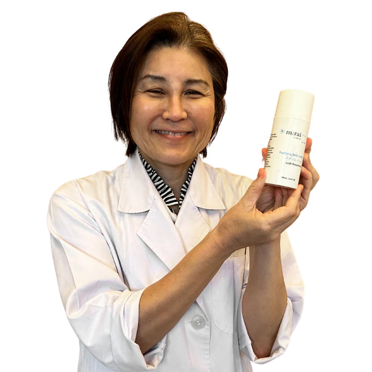 Dr. Yoko proudly presenting Mirai Clinical's deodorizing body lotion, specially formulated to combat nonenal body odor, showcasing its persimmon-infused benefits