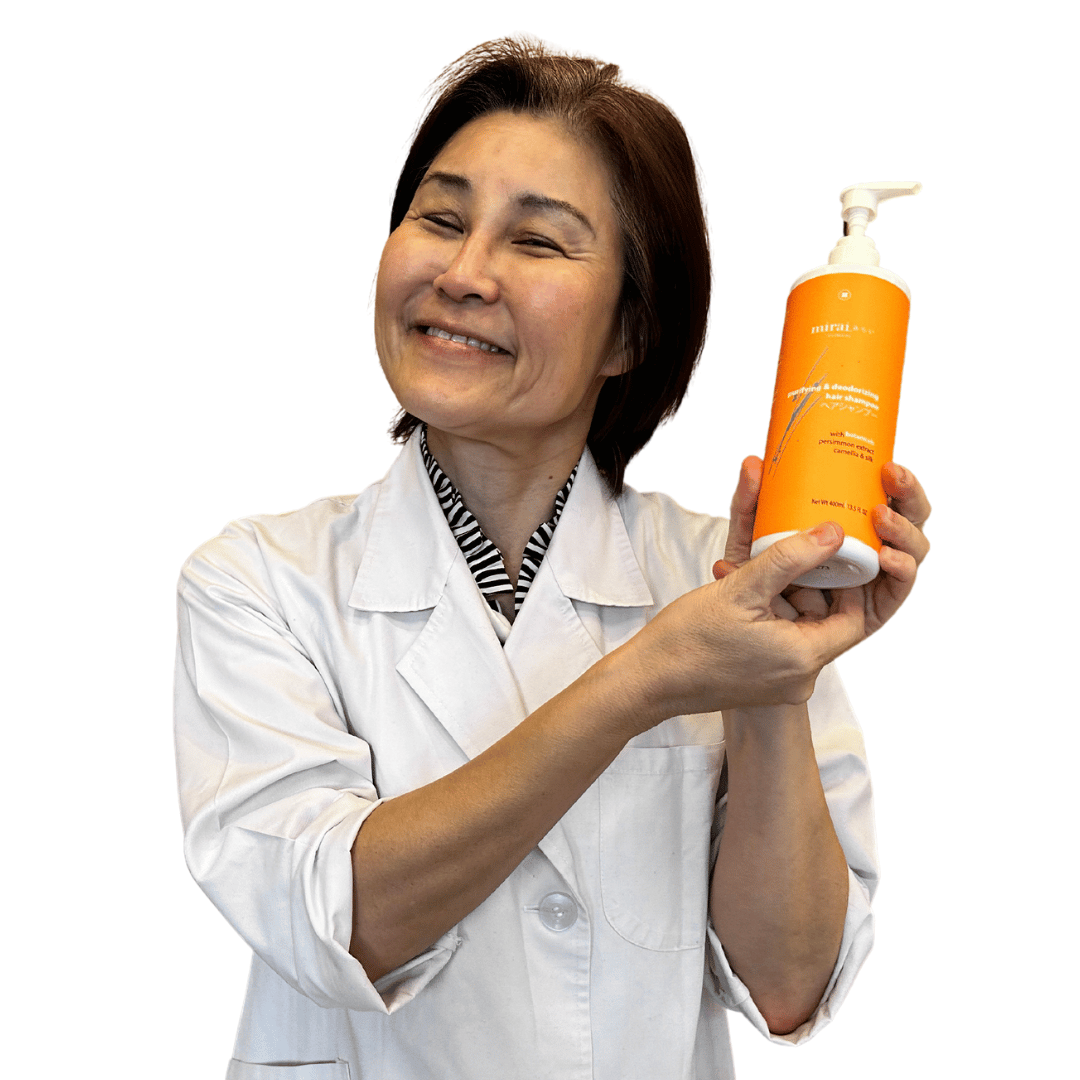 Dr. Yoko from Mirai Clinical proudly showcasing the Purifying & Deodorizing Hair Shampoo, formulated for optimal hair freshness and cleanliness.