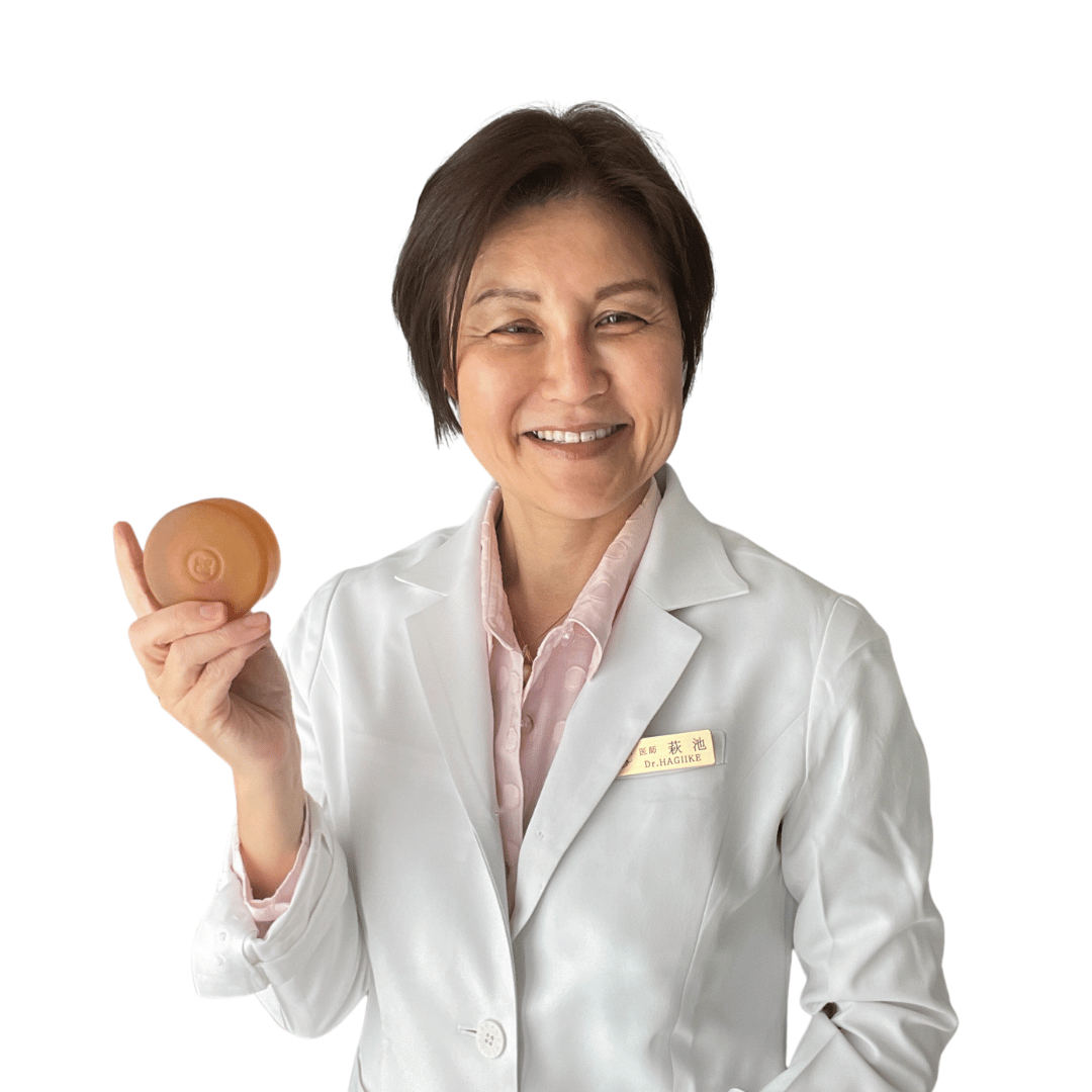 Dr. Yoko holding a Mirai Clinical deodorizing soap bar formulated with persimmon extract to combat nonenal-associated body odor.