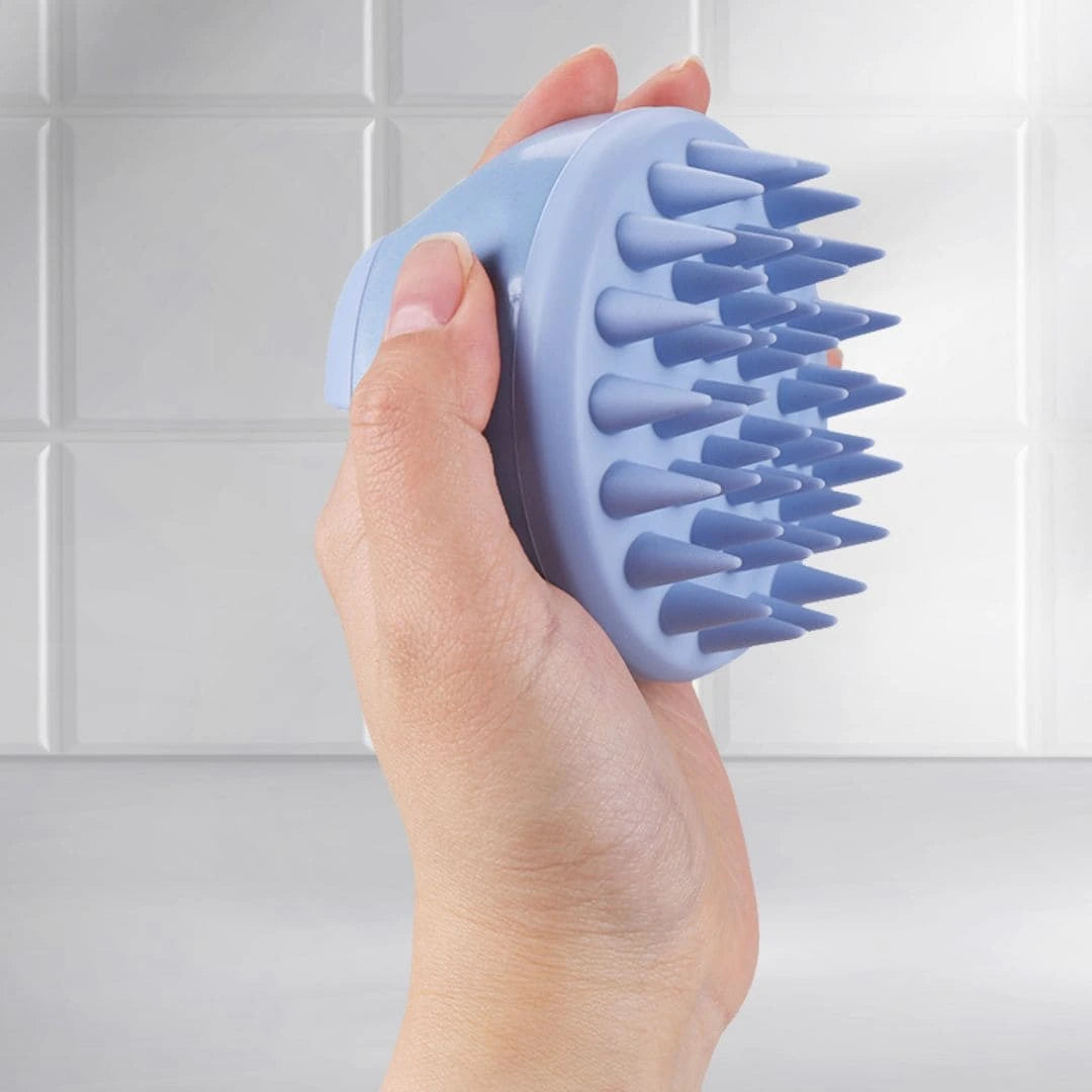 Side view of Mirai Clinical Scalp Massager held in hand, showcasing its ergonomic design and soft silicone bristles.