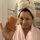Woman holding Mirai Clinical's Deodorizing Soap infused with Japanese Persimmon, targeting nonenal body odor