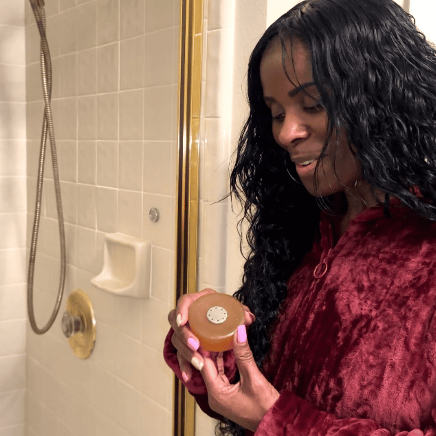 Woman proudly displaying Mirai Clinical's innovative soap bar with its accompanying magnet, emphasizing the brand's unique approach to soap storage and prolonging soap lifespan.
