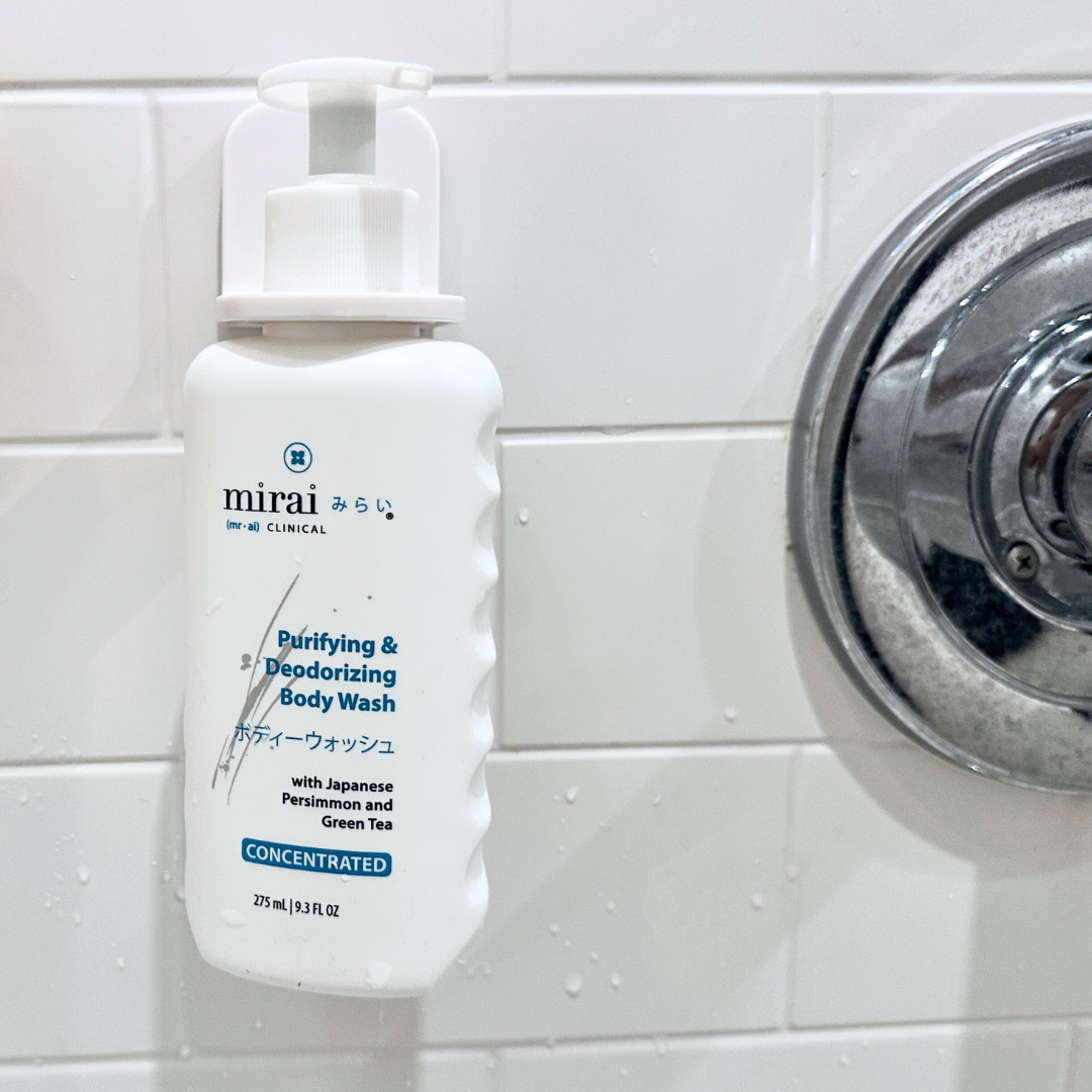 Mirai Clinical body wash securely mounted in holder, shower-ready.