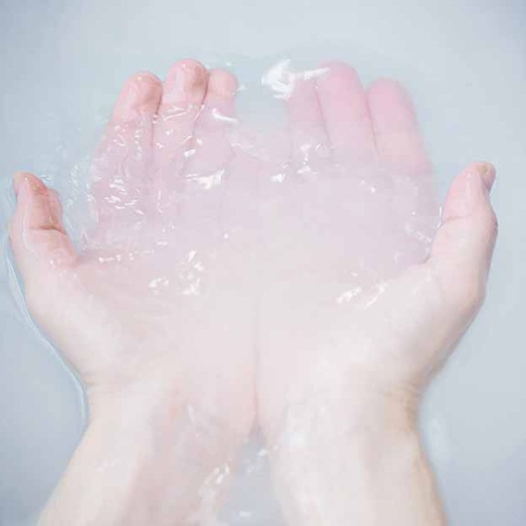 Hands immersed in water with Mirai Clinical bath salts for deodorizing.