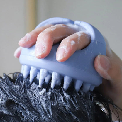 Close-up of Mirai Clinical Scalp Massager in use, lathering shampoo into hair with silicone bristles.