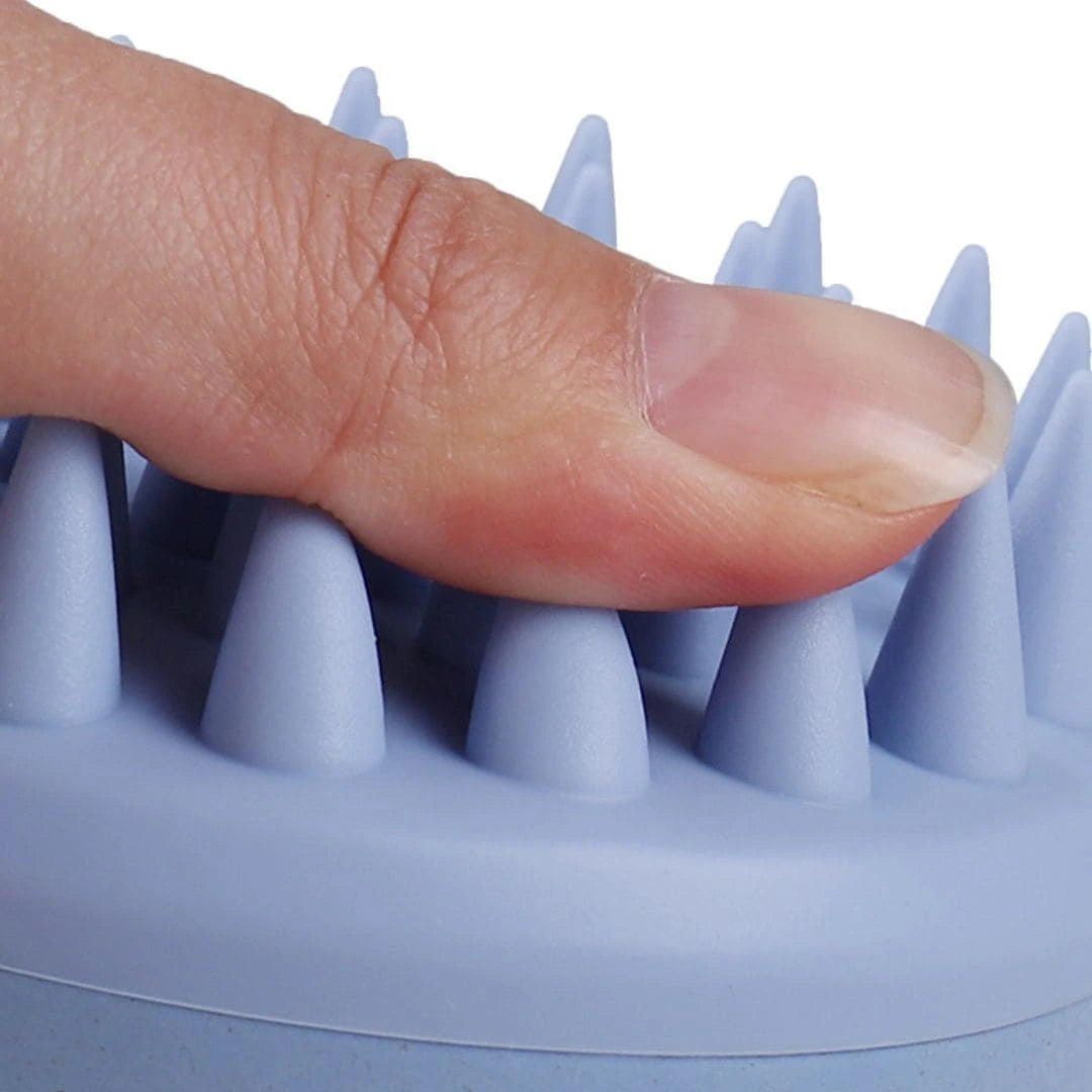 Close-up of Mirai Clinical Scalp Massager showing soft silicone bristles.