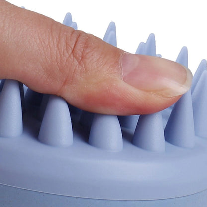 Close-up of Mirai Clinical Scalp Massager showing soft silicone bristles.