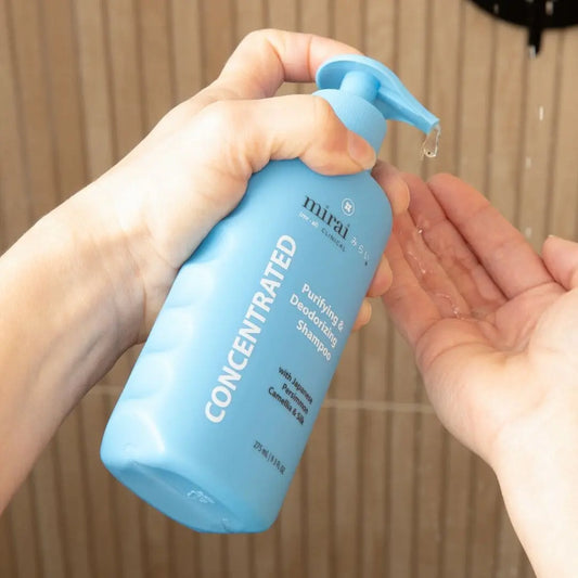 Mirai Clinical Purifying & Deodorizing Shampoo bottle with Japanese persimmon and camellia, designed to cleanse and nourish hair while deodorizing.