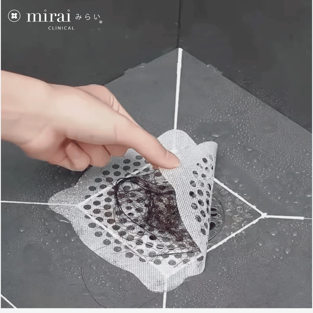 Demonstration of removing the hair catcher from Mirai Clinical, highlighting the trapped hair and showcasing its efficacy in preventing drain clogs