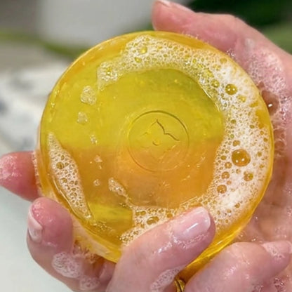 Hands holding citrus deodorizing soap with rich lather designed to cleanse skin and eliminate Nonenal aging odor naturally.