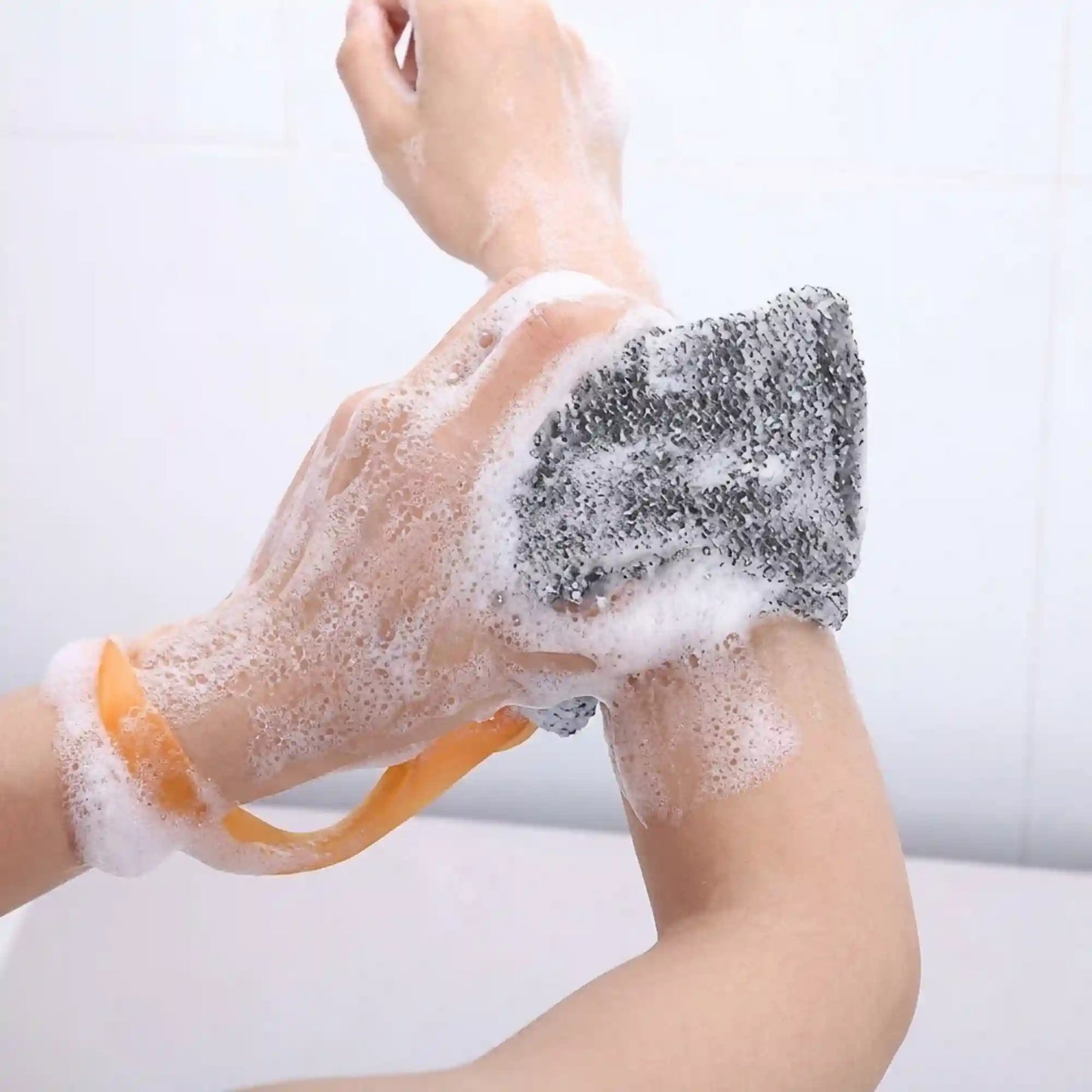 Hands lathering the Mirai Clinical soap saver bag on the arm