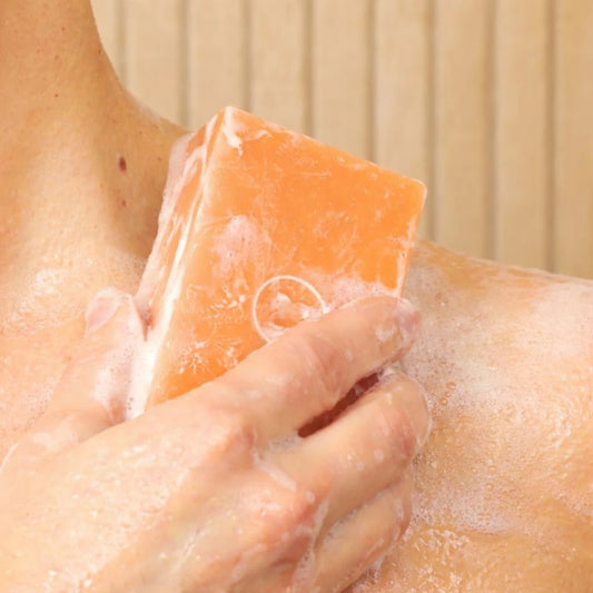 Lathering the Sensitive Soap Bar on skin, showing creamy foam and gentle cleansing for sensitive areas. Contains persimmon extract to target Nonenal body odor.