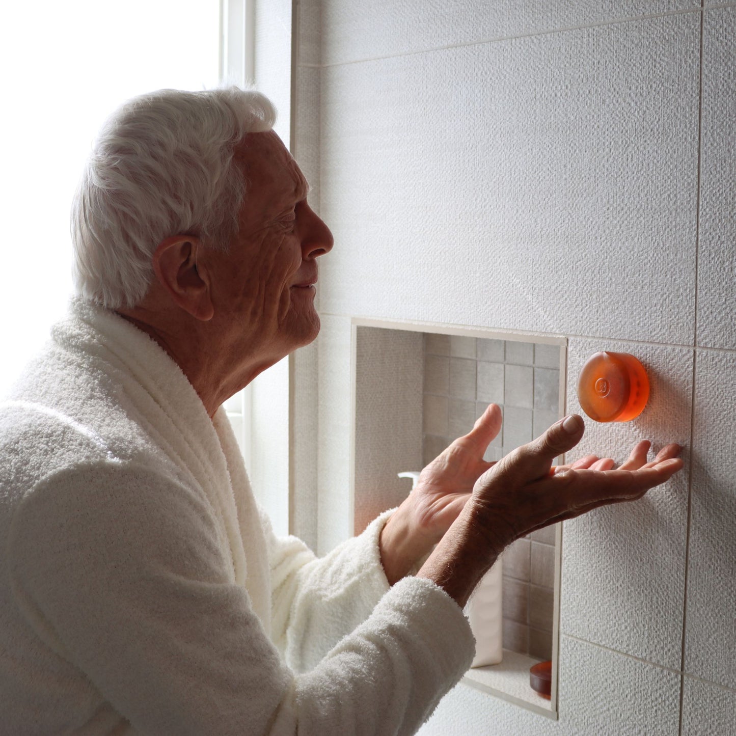 Elderly man utilizing Mirai Clinical's Magnetic Soap Bar Holder, designed for efficient soap storage and longevity.