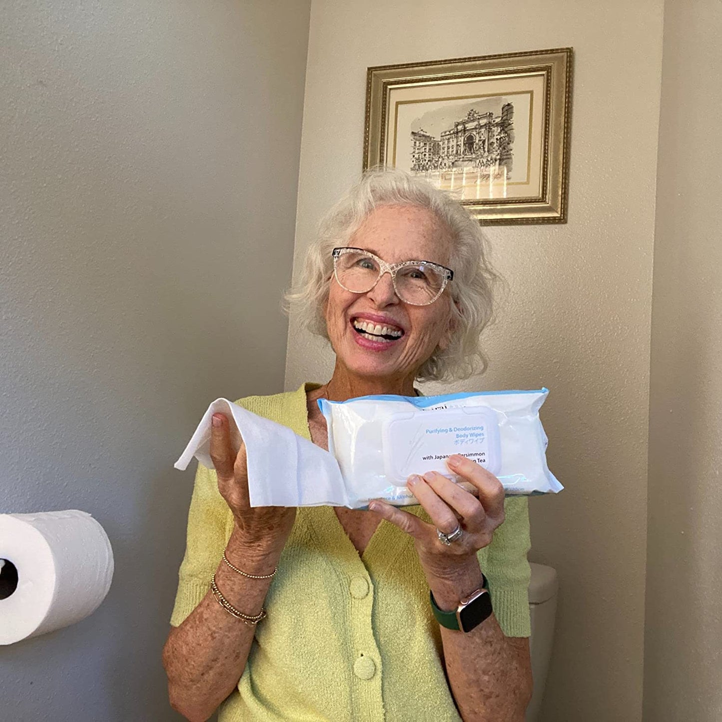 Woman confidently holding and displaying Mirai Clinical's deodorizing BodyWipe, infused with persimmon extract for nonenal body odor elimination.